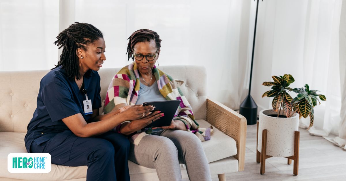 A professional caregiver reviewing care plans on a tablet with a senior at home, highlighting essential skills and qualifications of a caregiver