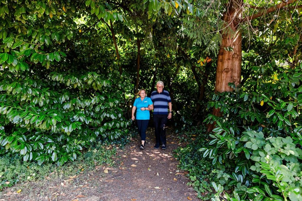 Image of Hero Home Care caregiver on a walk with a client.