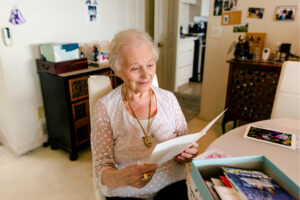 Image of a lady looking at a card.