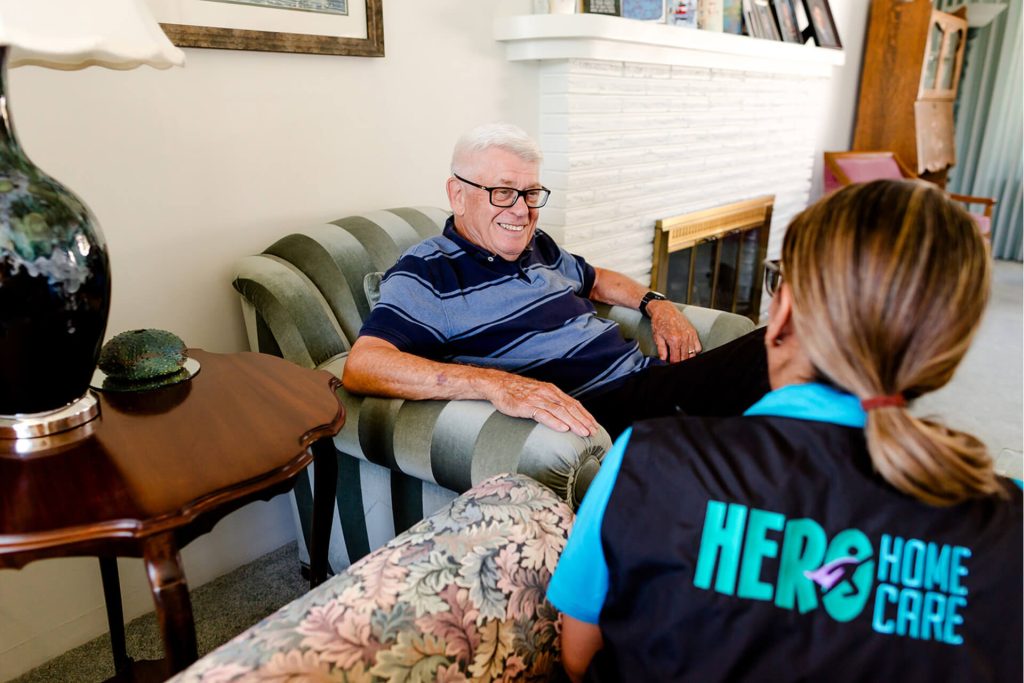 A man is seated, actively talking to a woman
