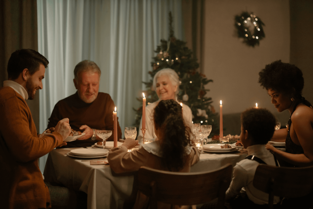 A family sits around a candlelit dinner table