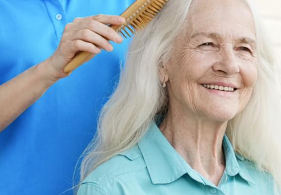 happy-young-caregiver-brushing-long-white-hair-smiling-femal
