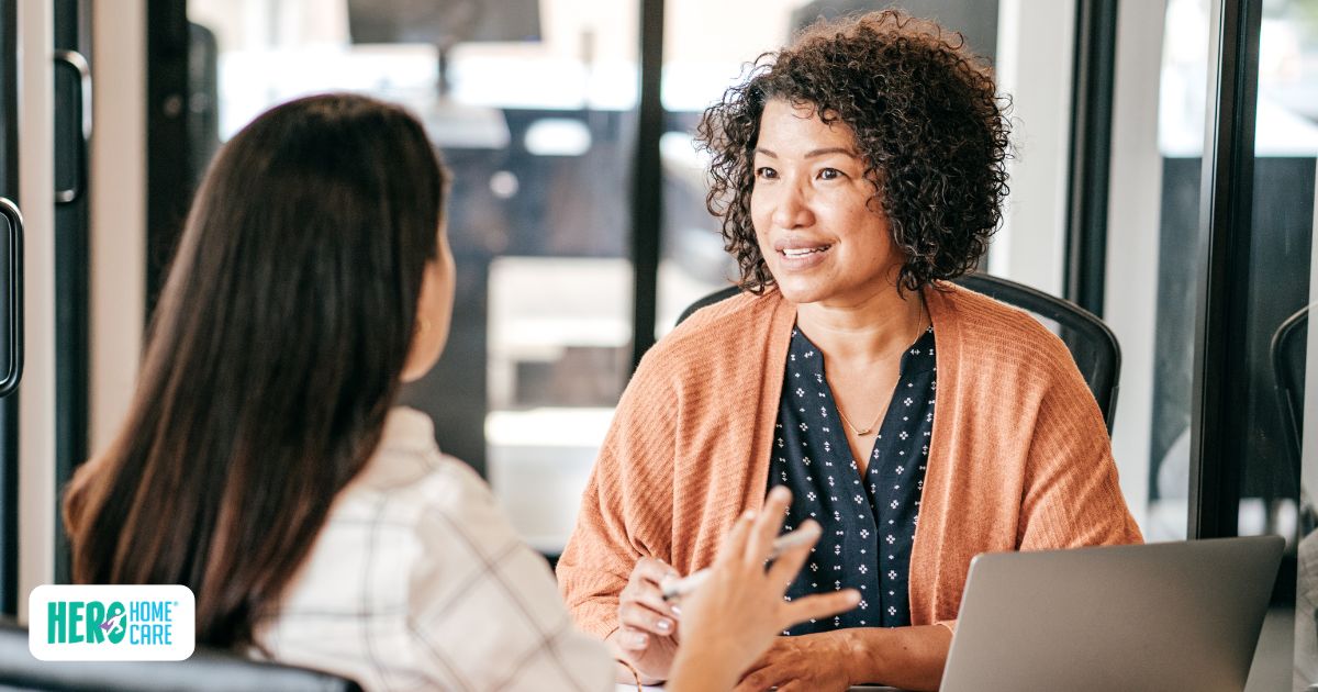Employee discussing caregiving responsibilities with manager in office