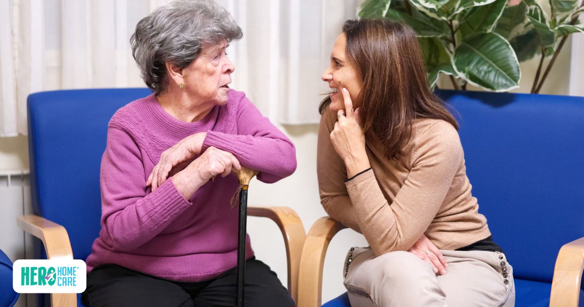 Senior woman and companion caregiver smiling during an initial trial visit at home