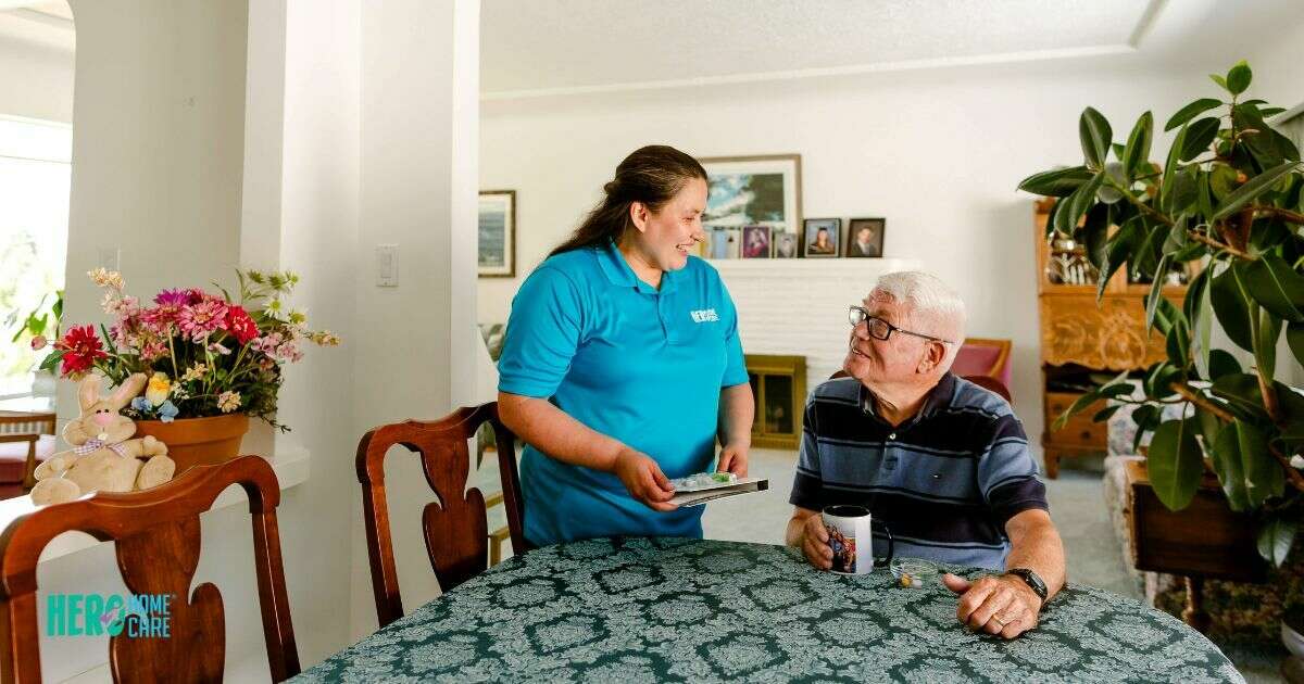 A local caregiver providing personalized support to a senior man in his dining room, showcasing 24-hour home care in North Vancouver.