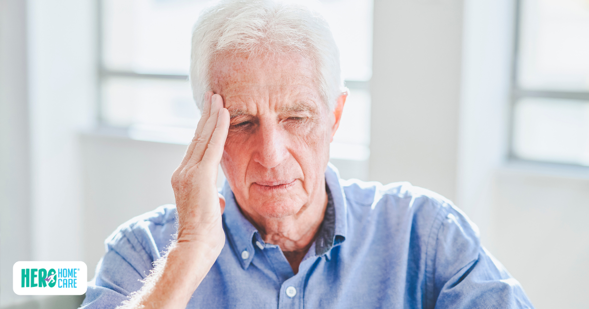 An elderly man with a distressed expression holding his hand to his head, illustrating symptoms of dementia such as misplacing things and being unable to retrace steps.