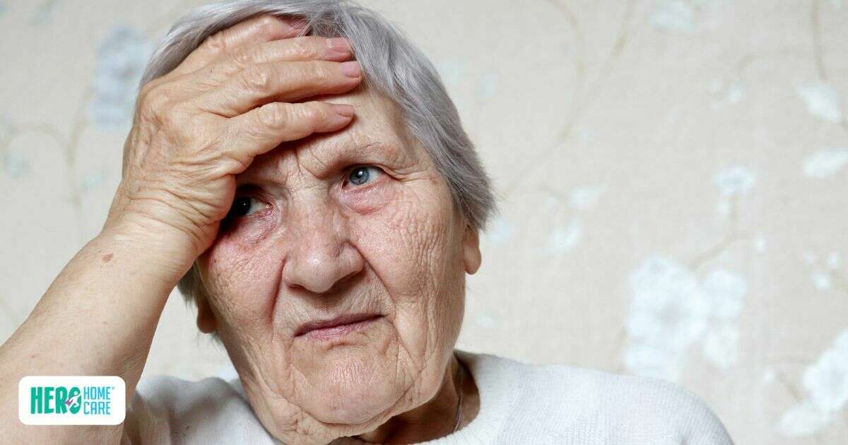 An aging woman appearing overwhelmed or in pain, serving as a visual representation of the common signs an elderly person might require round-the-clock senior care.