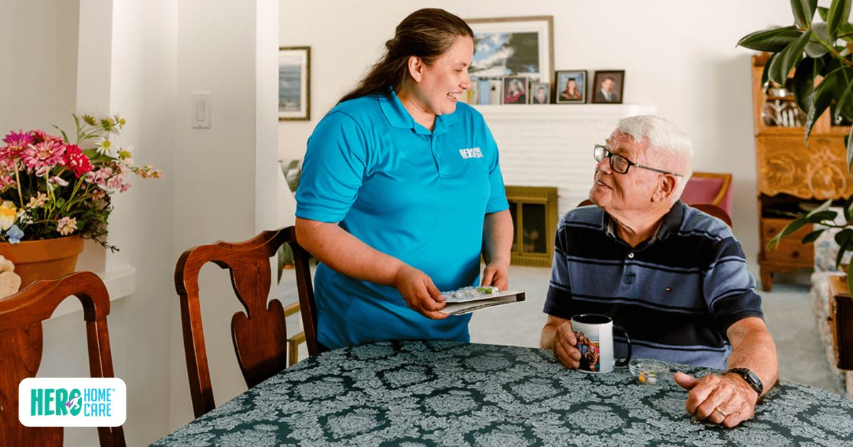 Caregiver delivering medication management services through Hero Home Care in a comfortable home setting