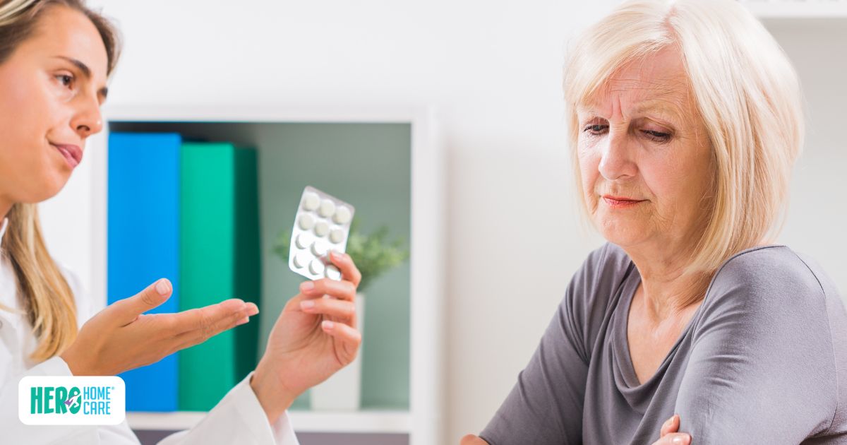Senior refuses to take medication during a discussion with a caregiver holding a pill pack