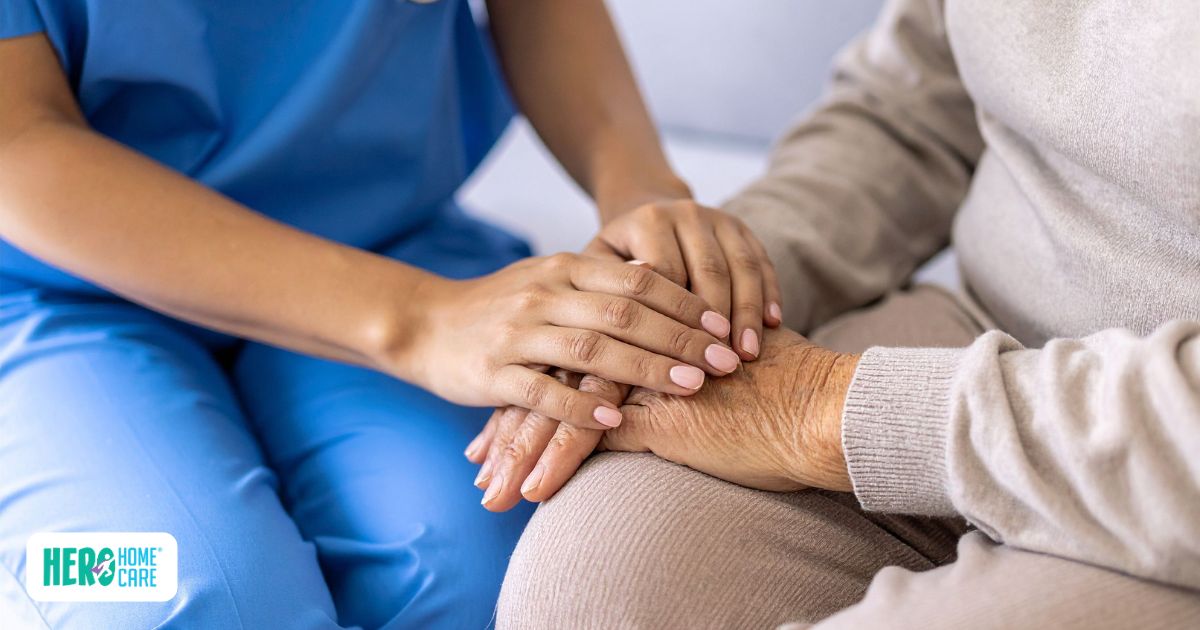 Caregiver holding a senior's hand while providing support and reassurance during the transition to home care