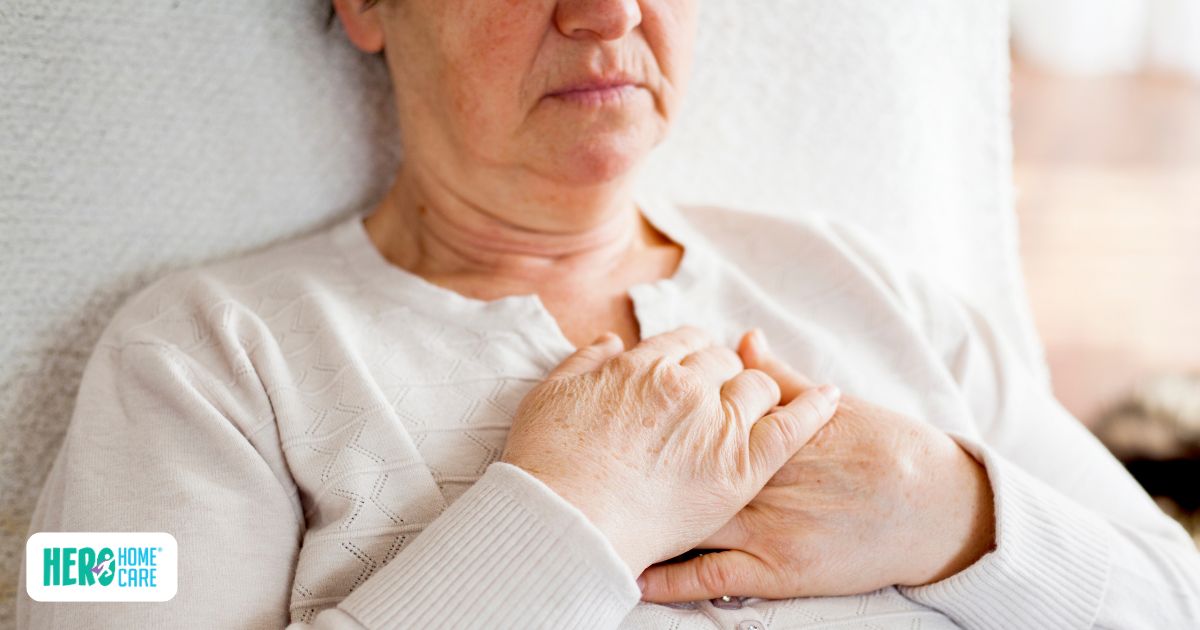 Senior recovering alone at home after surgery while experiencing discomfort, illustrating the potential health and safety risks of managing recovery without support