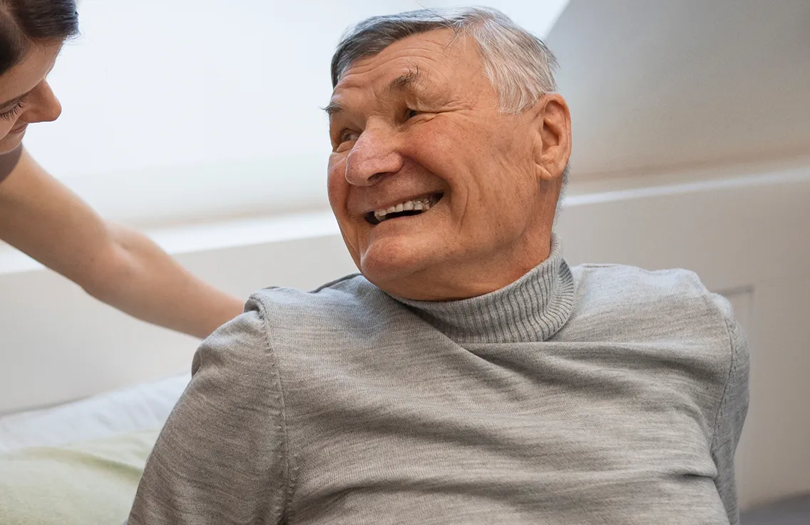 Caregiver assisting an elderly stroke survivor at home