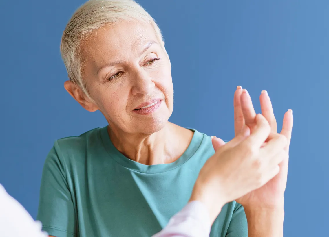 Senior with Parkinson's in a therapy session with a health professional