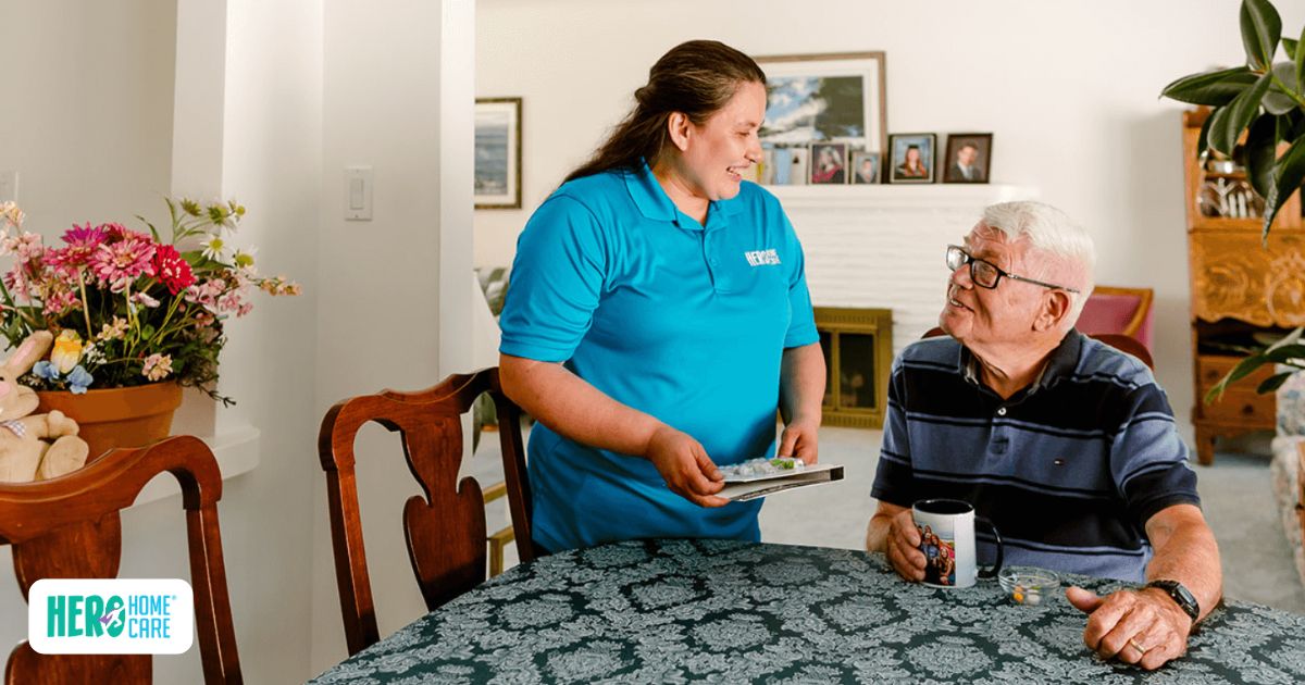 Professional home caregiver assisting an older adult with medication as part of a personalized home care plan in a comfortable home setting.