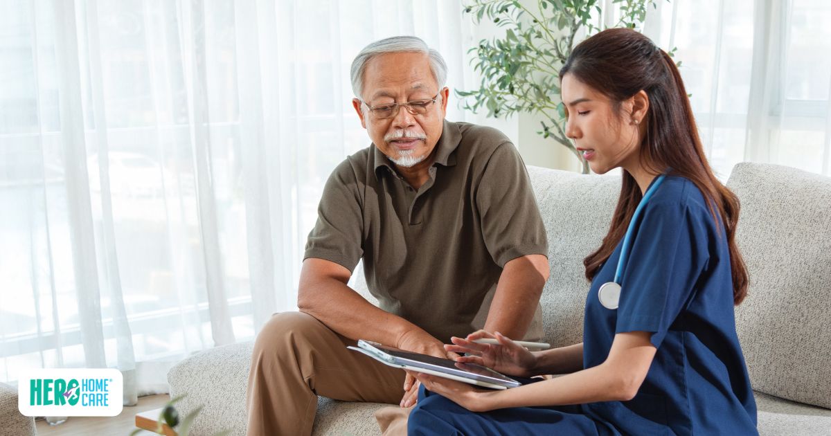 A healthcare professional discussing dementia and Alzheimer's resources with an older adult during a home care visit in North Vancouver.